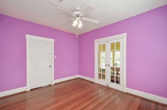 unfurnished room with french doors, baseboards, and wood finished floors