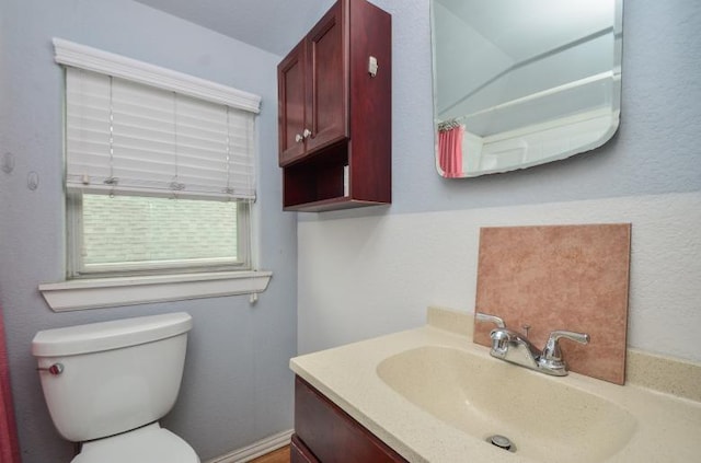 bathroom featuring vanity and toilet