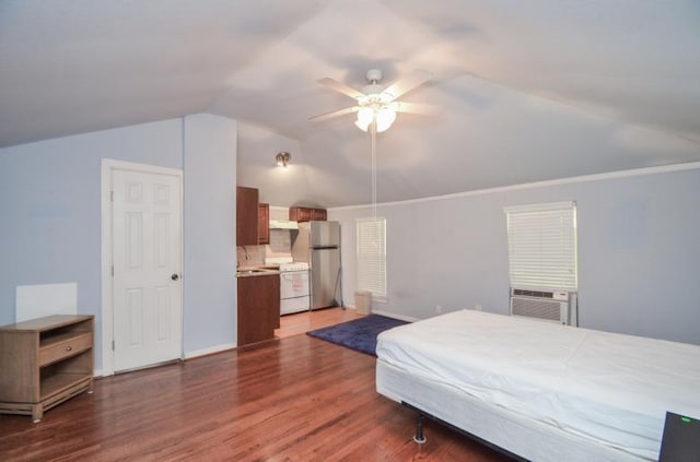 bedroom featuring dark wood finished floors, freestanding refrigerator, cooling unit, baseboards, and vaulted ceiling