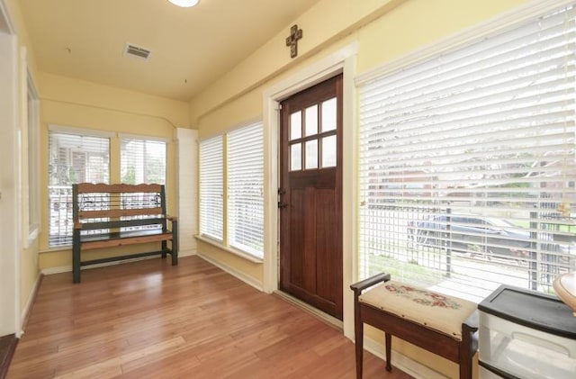 foyer entrance featuring visible vents and light wood finished floors