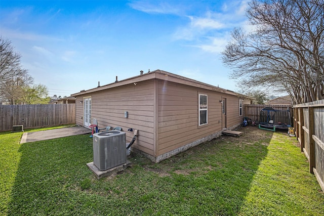 view of property exterior featuring a fenced backyard, central air condition unit, a patio, and a yard