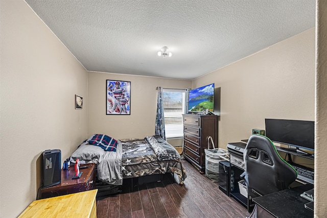 bedroom with dark wood finished floors and a textured ceiling