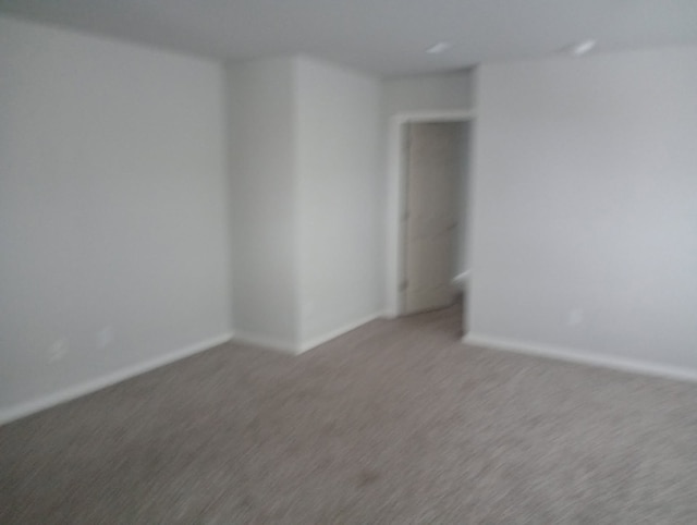 carpeted empty room with baseboards