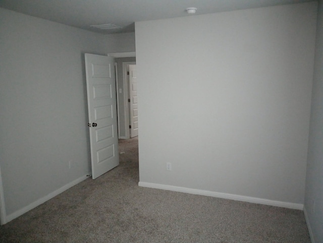 unfurnished room featuring baseboards and carpet floors