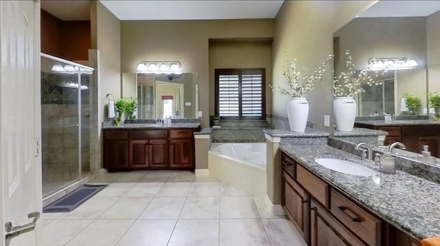 bathroom featuring tile patterned flooring, visible vents, a shower stall, a garden tub, and a sink