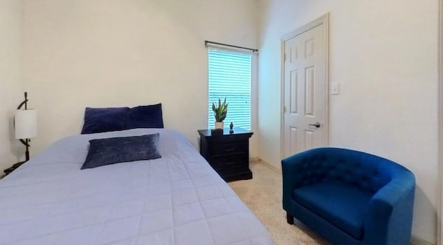 bedroom featuring light colored carpet