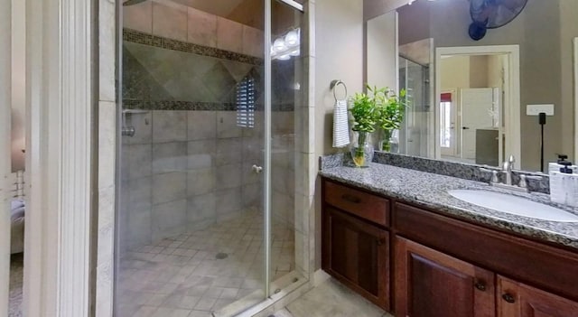 full bath featuring tile patterned flooring, a shower stall, and vanity