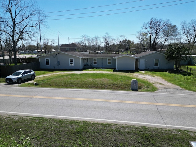 view of front of home with driveway and a front lawn