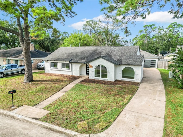 view of front facade featuring a front lawn, fence, brick siding, and roof with shingles