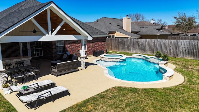 view of pool with a ceiling fan, fence, an outdoor living space, a pool with connected hot tub, and a patio area