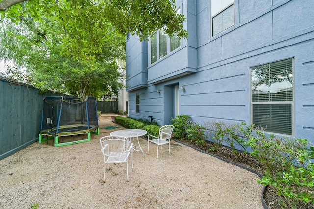 view of patio featuring a fenced backyard and a trampoline