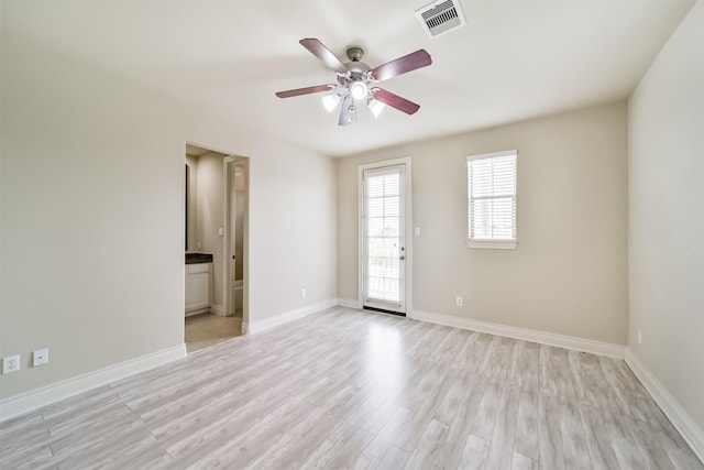 unfurnished room with baseboards, visible vents, light wood finished floors, and ceiling fan