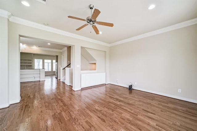 unfurnished living room with baseboards, ornamental molding, recessed lighting, wood finished floors, and a ceiling fan