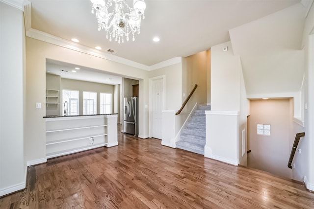 unfurnished living room with recessed lighting, visible vents, wood finished floors, and crown molding