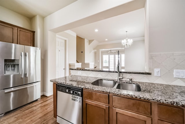 kitchen with light stone counters, stainless steel appliances, and decorative backsplash