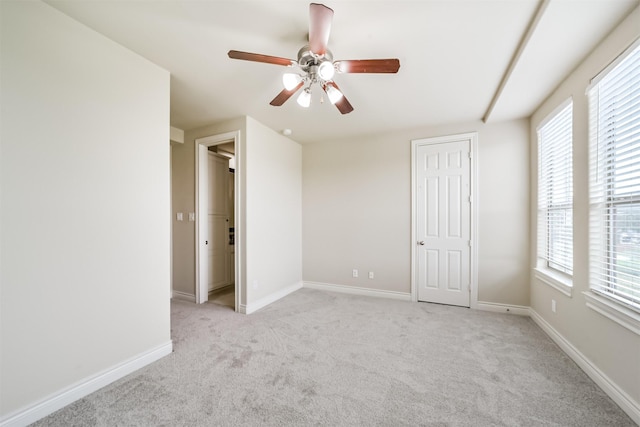 unfurnished bedroom featuring baseboards, ceiling fan, and carpet flooring