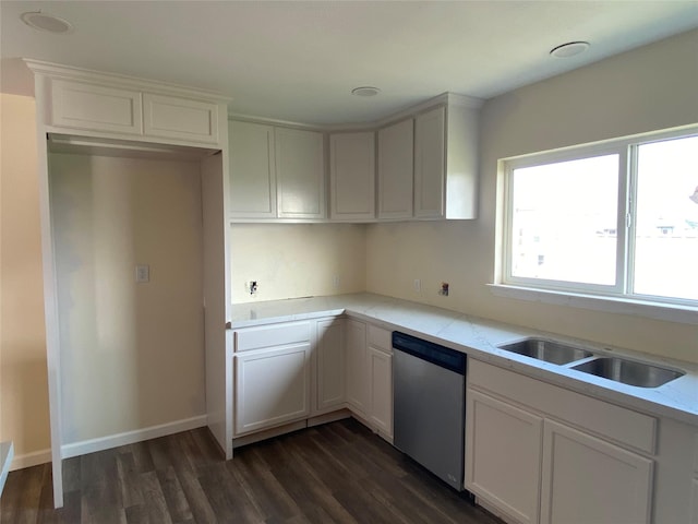 kitchen featuring baseboards, dishwasher, dark wood-style flooring, white cabinetry, and a sink