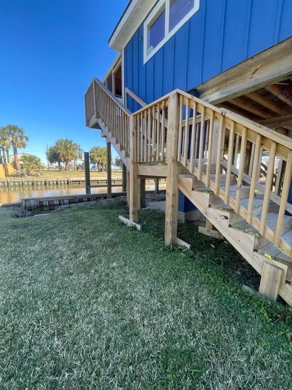 view of yard with stairs and a water view