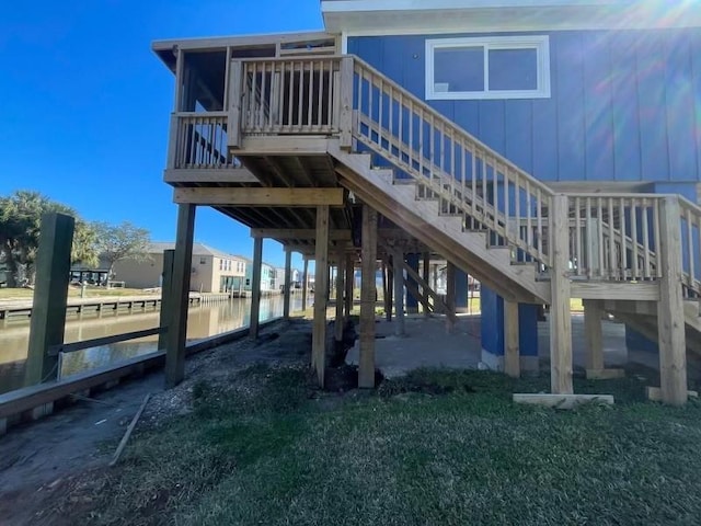 back of house featuring stairs and a water view