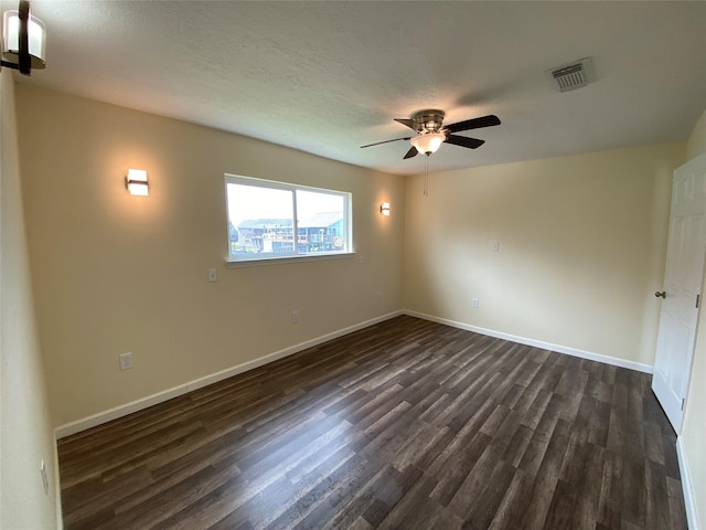 9 Flounder Cir, Freeport, TX 77541 - spare room featuring dark wood-style floors and a ceiling fan