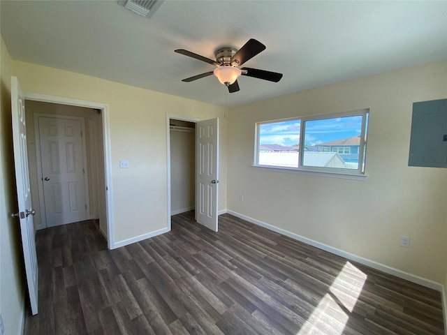 9 Flounder Cir, Freeport, TX 77541 - unfurnished bedroom with electric panel, dark wood-style flooring, a closet, and a ceiling fan