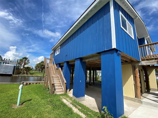 9 Flounder Cir, Freeport, TX 77541 - view of jungle gym featuring stairs, a water view, and a lawn