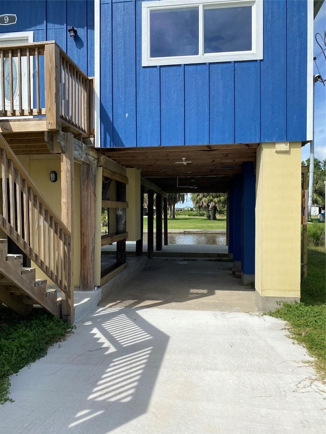 9 Flounder Cir, Freeport, TX 77541 - view of exterior entry featuring a water view, concrete driveway, and board and batten siding