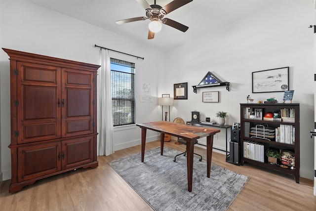 home office featuring light wood finished floors, baseboards, and ceiling fan