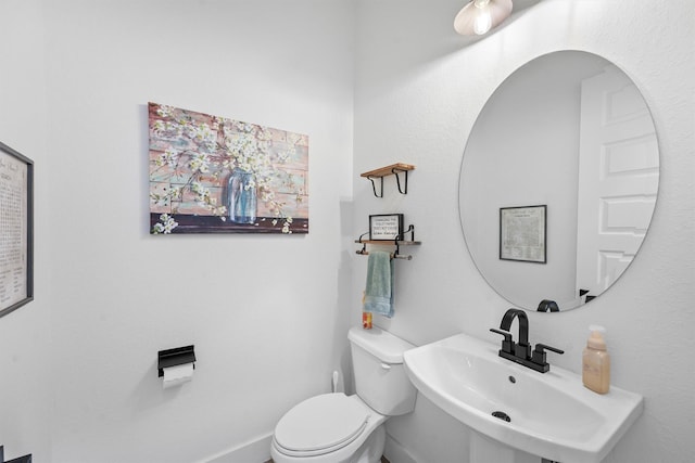 bathroom featuring toilet and a sink