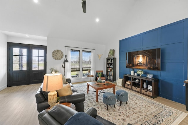 living area featuring recessed lighting, light wood-type flooring, and high vaulted ceiling