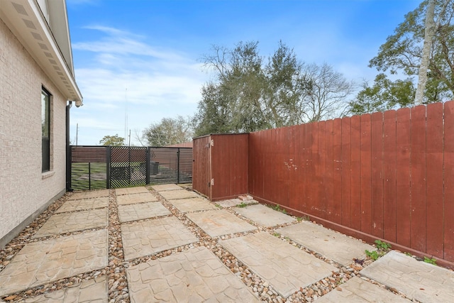 view of patio with a gate and fence