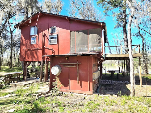 view of outdoor structure with a sunroom