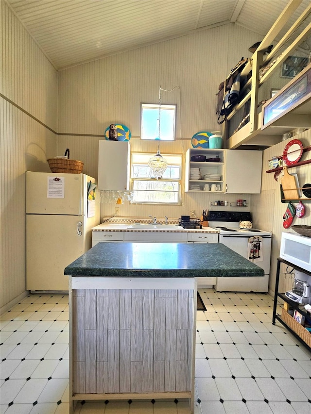 kitchen featuring open shelves, a kitchen island, white appliances, light floors, and vaulted ceiling