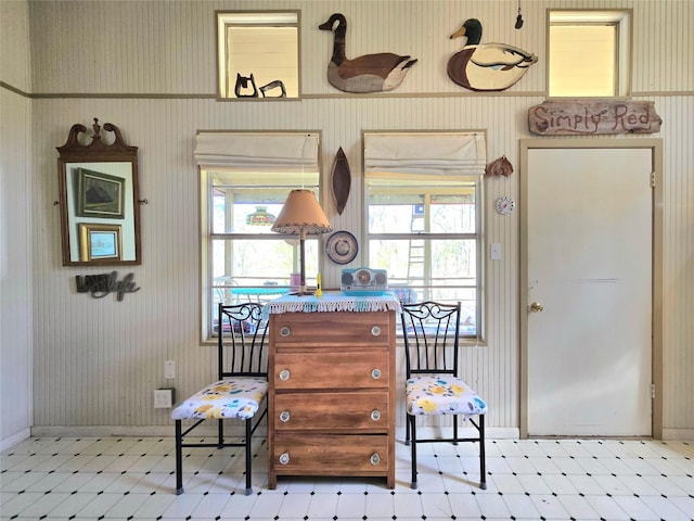 interior space featuring tile patterned floors, baseboards, and wallpapered walls