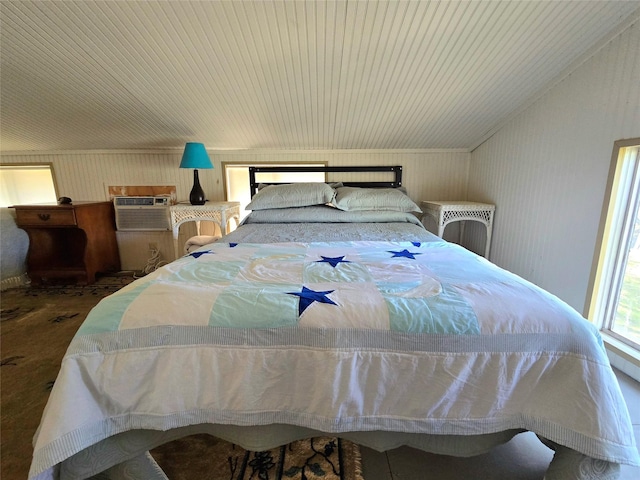 bedroom with an AC wall unit and lofted ceiling