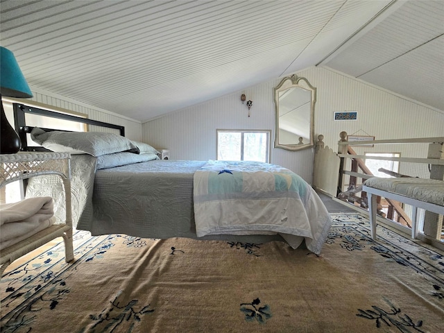 bedroom with vaulted ceiling, metal wall, and carpet