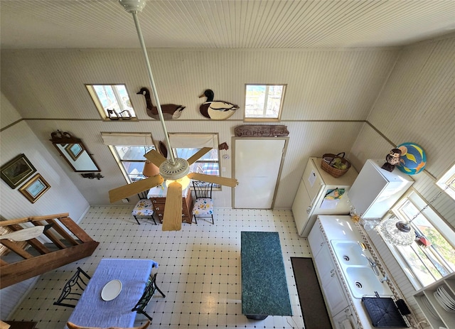 living area with tile patterned floors and ceiling fan