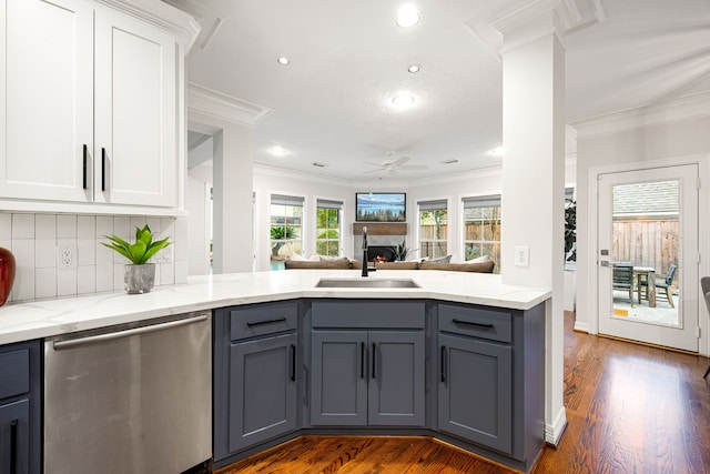 kitchen with a sink, gray cabinets, open floor plan, and stainless steel dishwasher