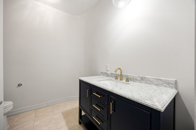 bathroom featuring vanity, tile patterned floors, toilet, and baseboards