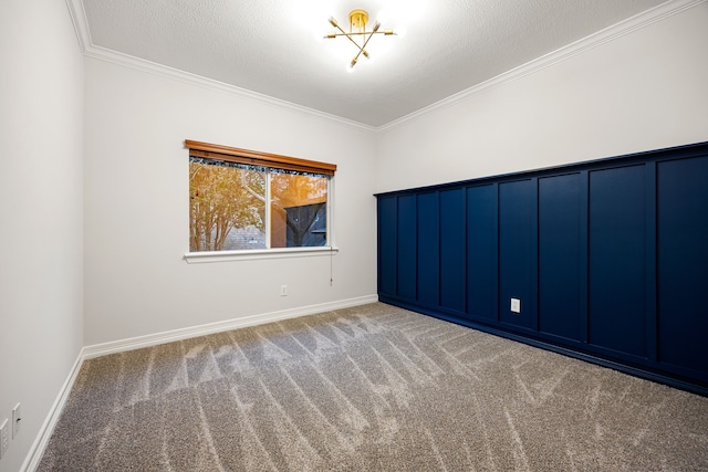 empty room with carpet, ornamental molding, and a textured ceiling