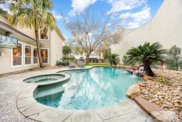 view of swimming pool featuring a patio, a fenced backyard, and a pool with connected hot tub