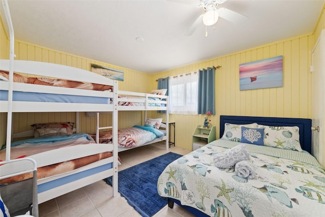 tiled bedroom with a ceiling fan