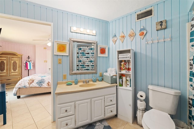 ensuite bathroom with tile patterned flooring, visible vents, ensuite bathroom, vanity, and a ceiling fan