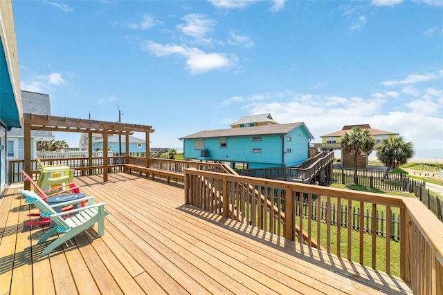 wooden deck featuring fence and a pergola