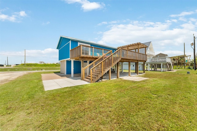 back of property featuring stairs, a lawn, and a wooden deck