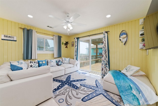 living area with a wealth of natural light, visible vents, recessed lighting, and a ceiling fan