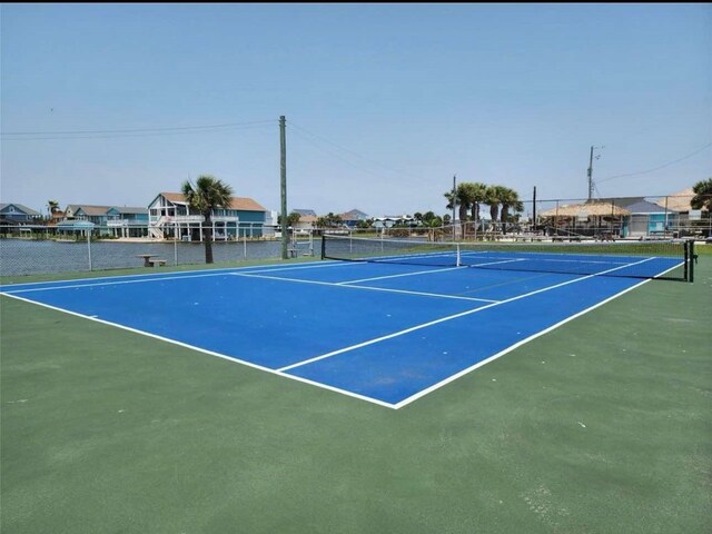 view of sport court with fence