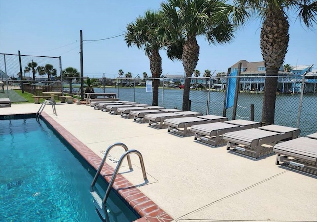 community pool featuring a patio and fence