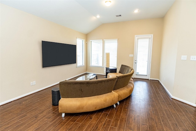 living area featuring dark wood finished floors, visible vents, baseboards, and vaulted ceiling