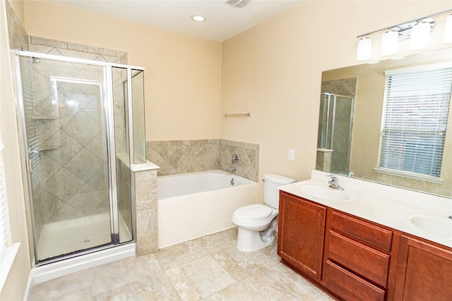 full bathroom with double vanity, a sink, a shower stall, a garden tub, and toilet